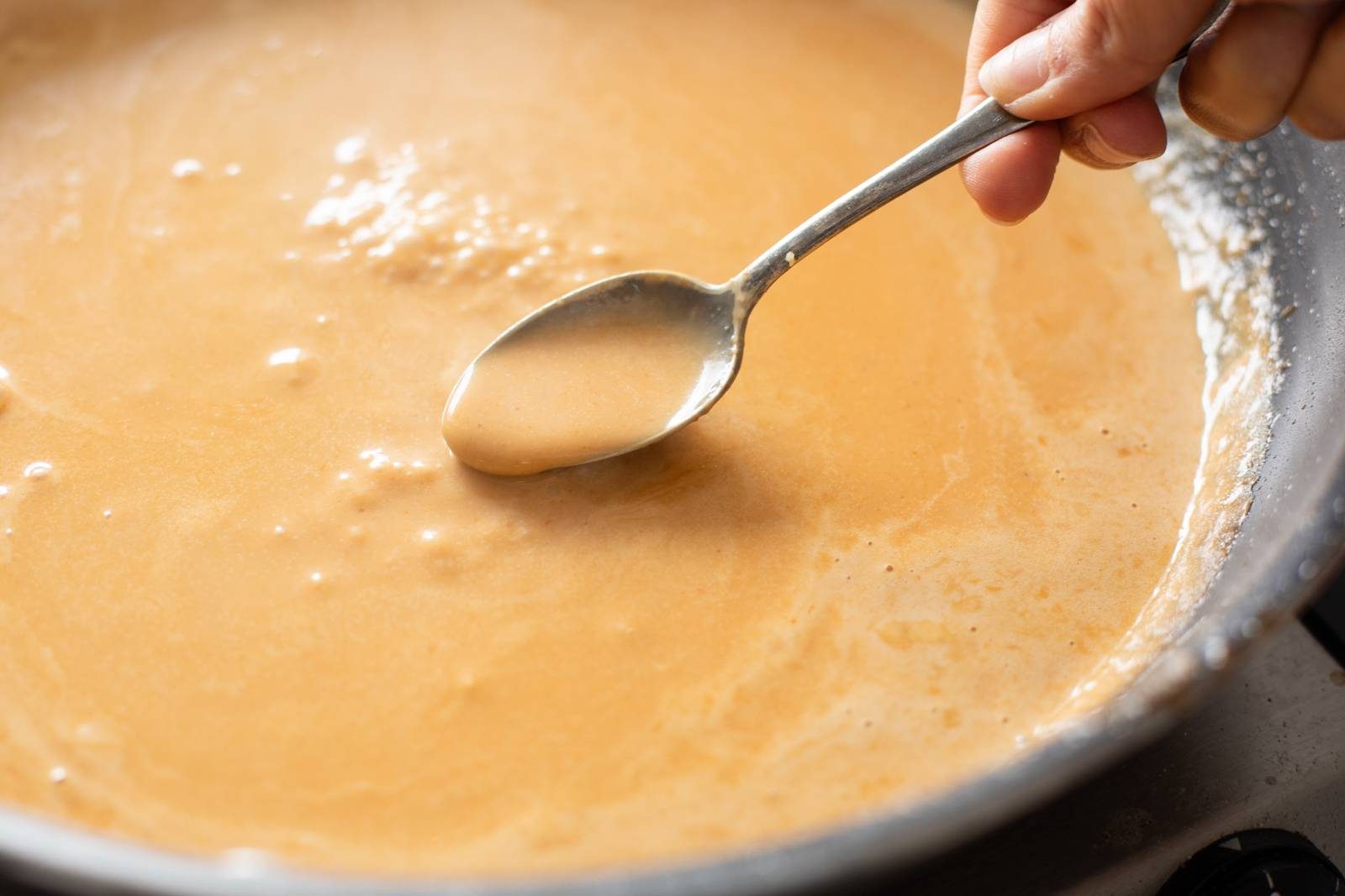 Ramen broth in a skillet.