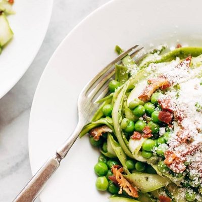 Pesto Asparagus Noodles in bowl with forks.