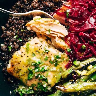 Baked Salmon in a bowl with lentils, green beans, and sauerkraut.