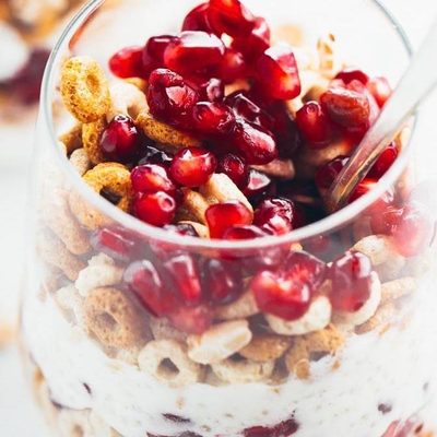 5 Minute Honey Yogurt Quinoa Parfait in a glass with a spoon.