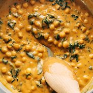 Coconut curry chickpeas with spinach in a pan.