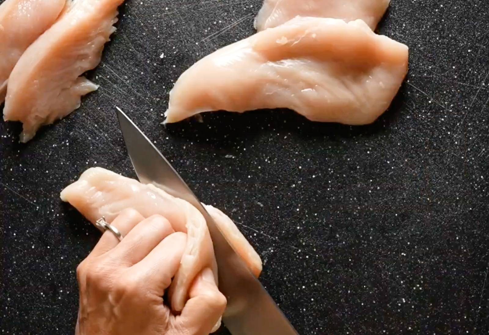 Slicing chicken lengthwise.