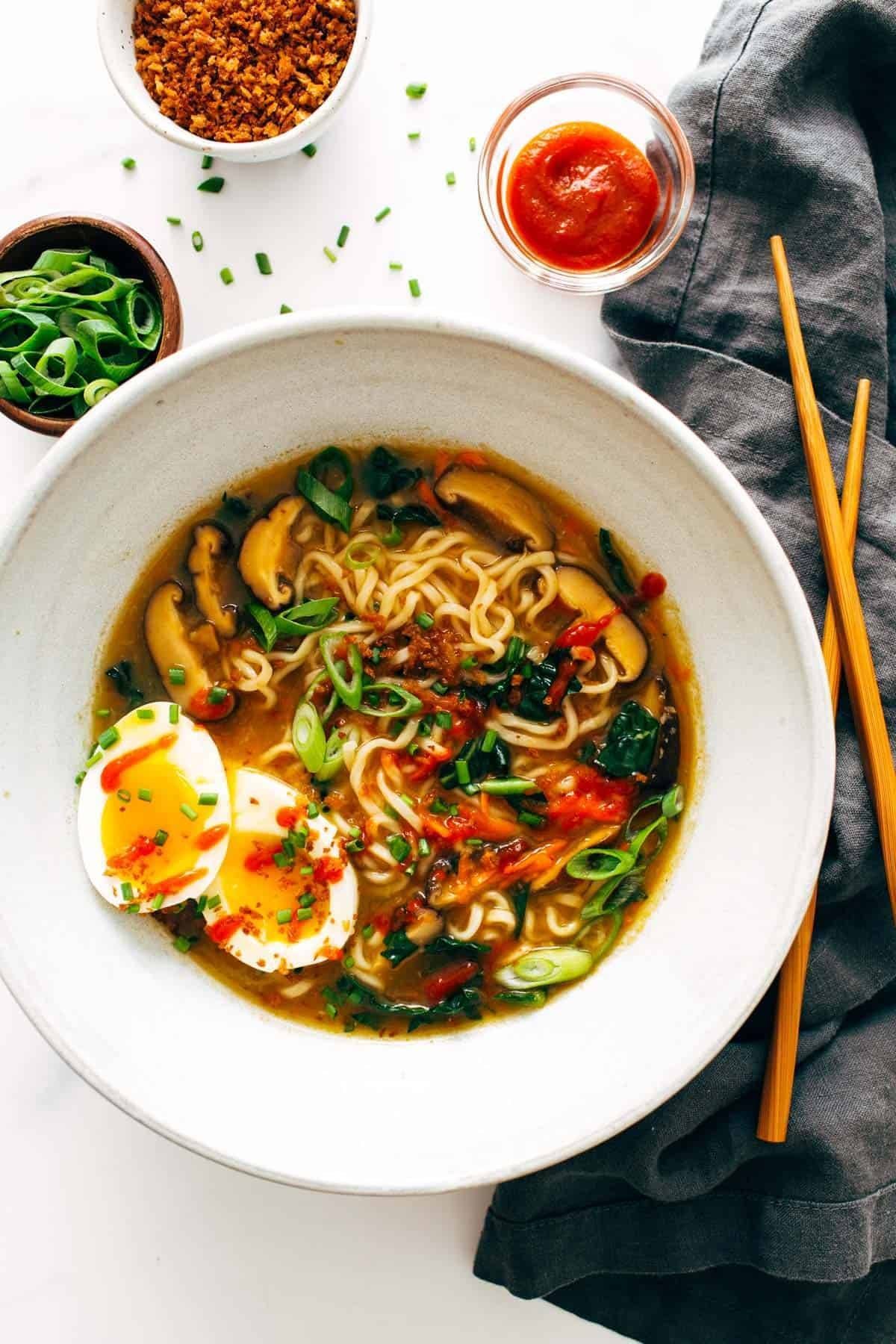 Quick Homemade Ramen - comes to life with fresh vegetables and herbs in just in 20 minutes! | pinchofyum.com Quick Homemade Ramen in a bowl with soft egg and chopsticks.