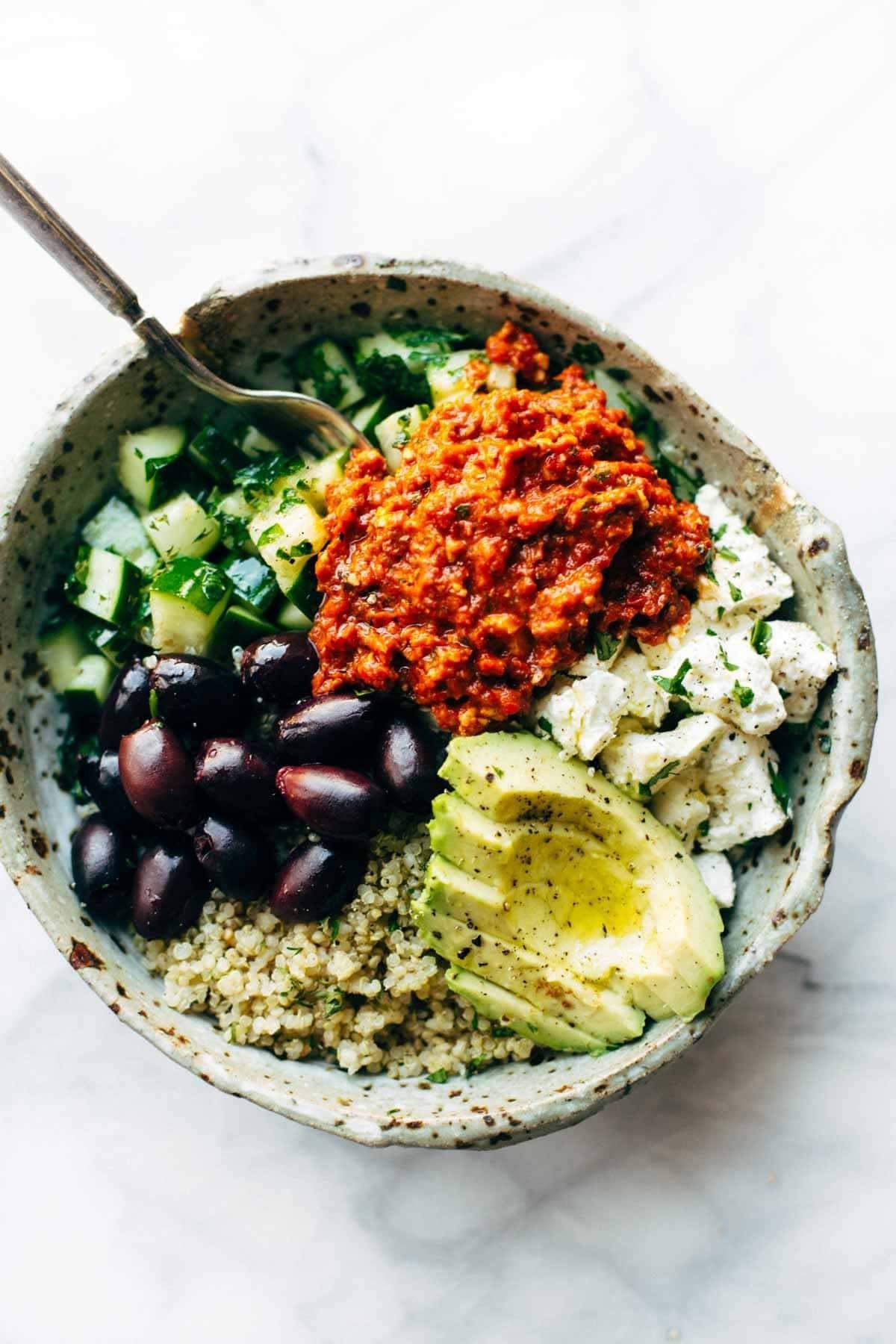 Grains, herbs, and vegetables arranged in a bowl.