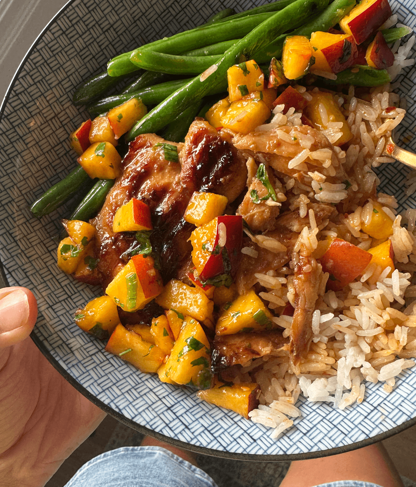 Teriyaki chicken in a bowl with rice, salsa, and green beans.