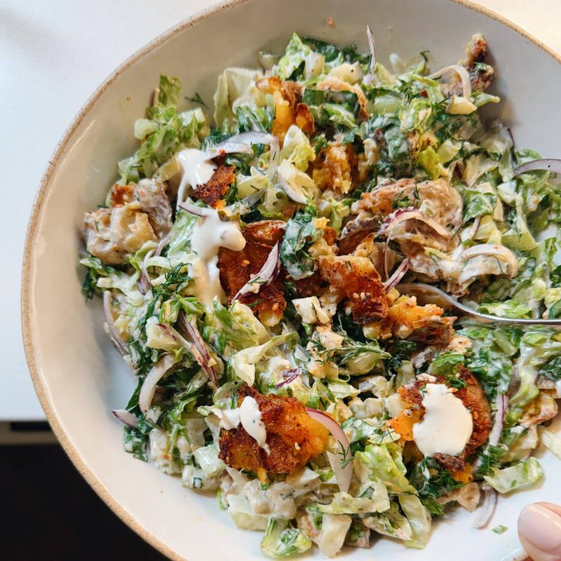 Crispy smashed potato salad in a bowl.