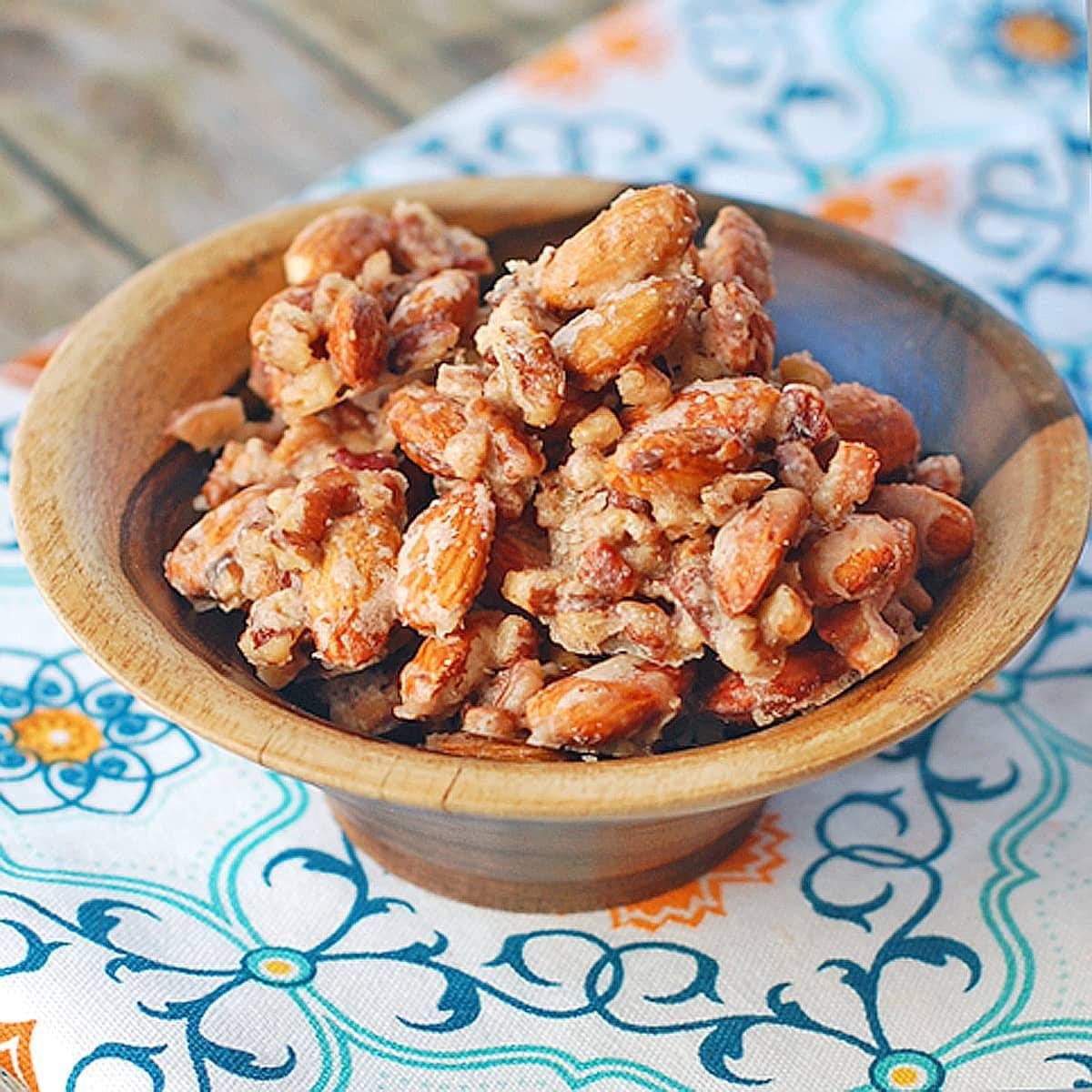Maple vanilla almond clusters in a wooden bowl.
