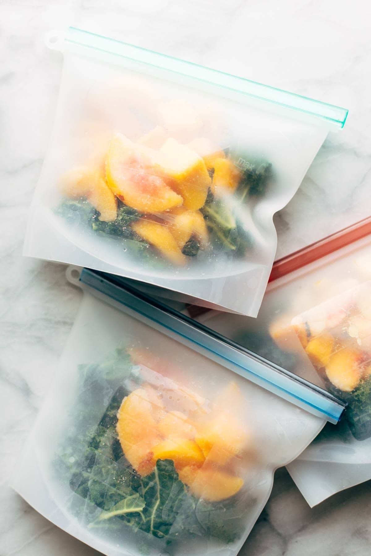 Green smoothie ingredients in freezer bags.